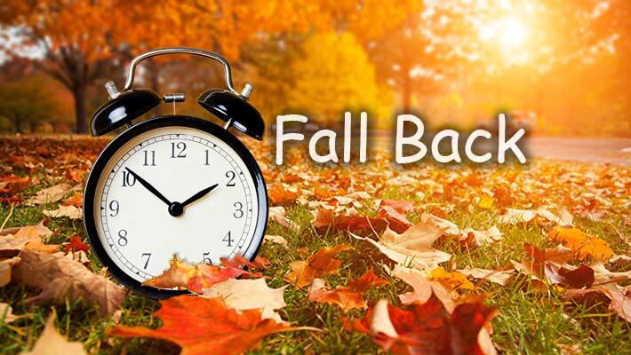 Fall leaves with an alarm clock and text that reads Fall Back.